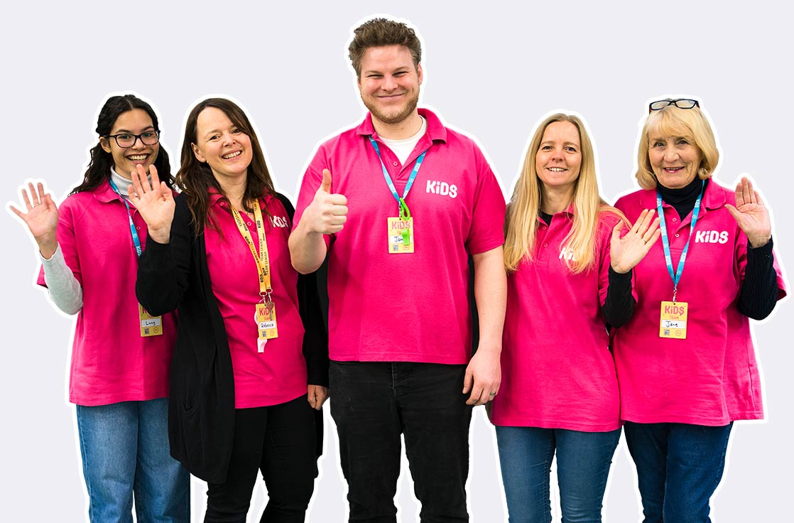 A group photo of the kids team wearing their pink t-shirts